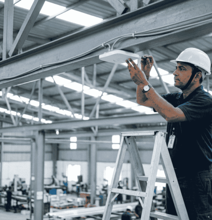 WiFi solution for factory shed: technician fitting a ceiling access point